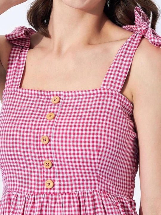 A light cotton dress with a flared shape and check pattern.